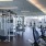 Large fitness center with various equipment and a great cityscape view