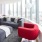 Penthouse living room area with curved windows overlooking cityscape