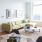 Large living room area with lots of natural light, wood-like flooring, and city views