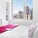 Bedroom with lots of natural light and a window view of the city